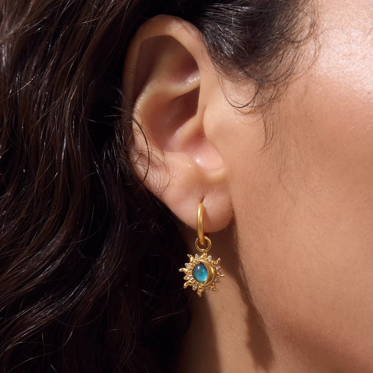 Sol Earrings gold celestial huggies with blue centre stones